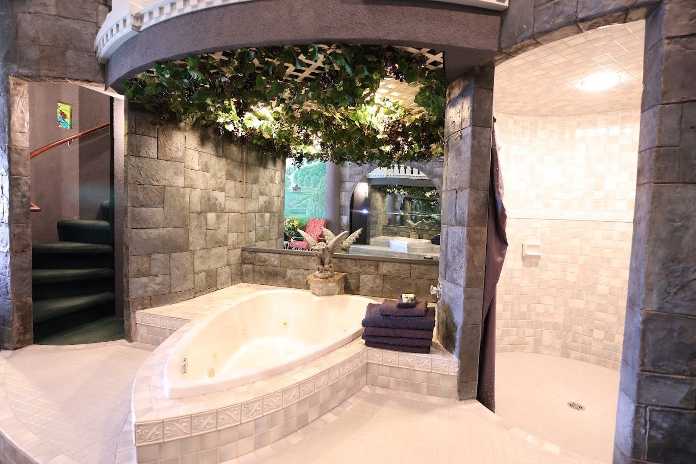 A bathroom with a jacuzzi tub and a staircase