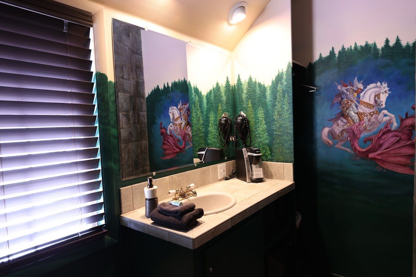 A bathroom with a painting of a horse on the wall