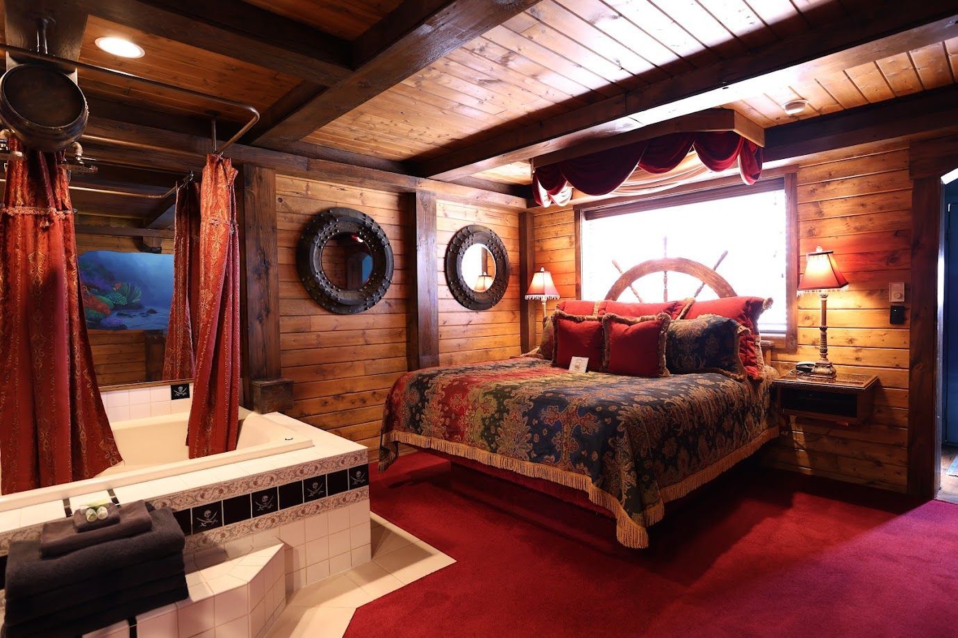 A bedroom with a canopy bed and a jacuzzi tub.