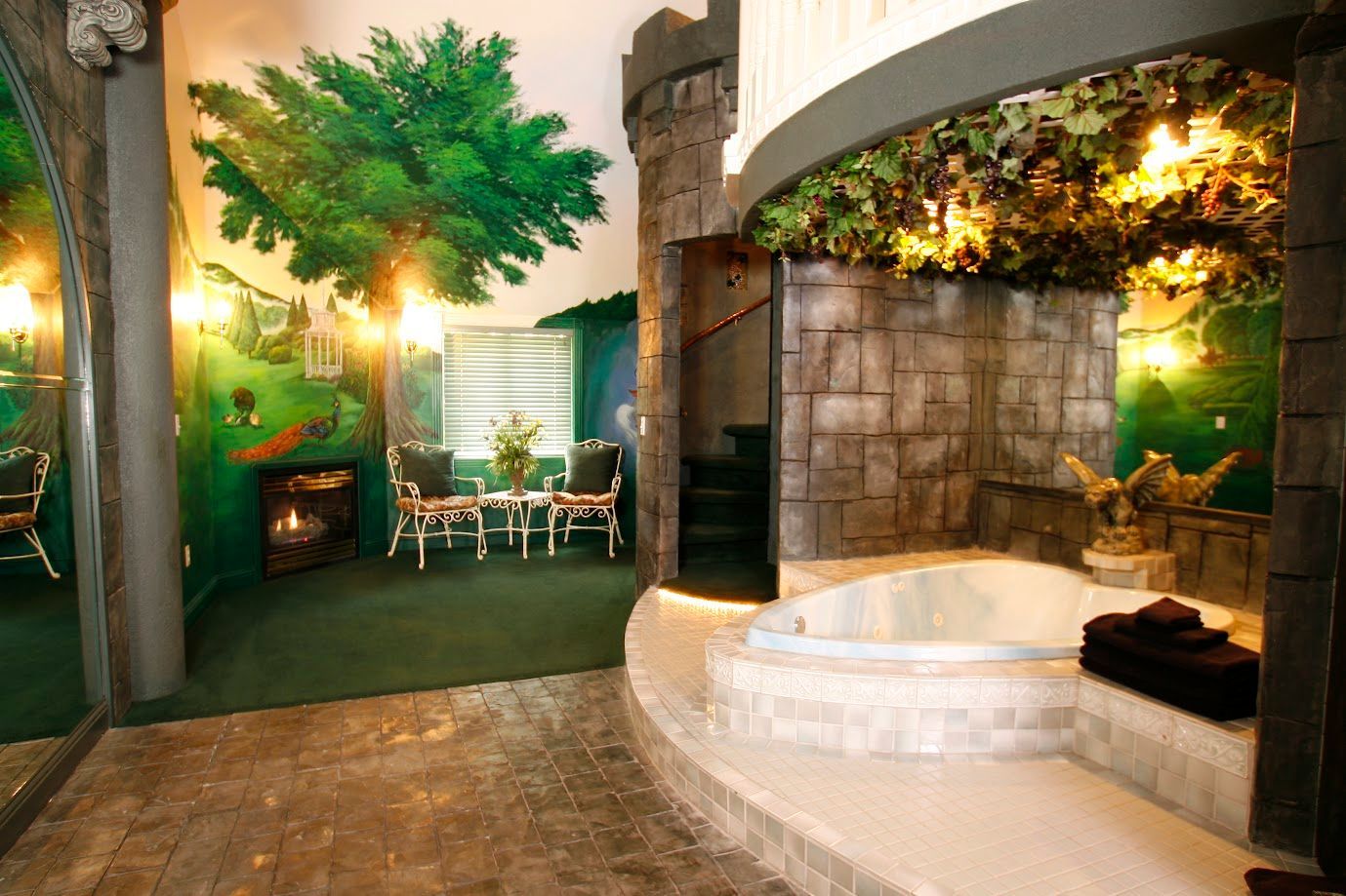 A bathroom with a jacuzzi tub and a painting of a tree on the wall