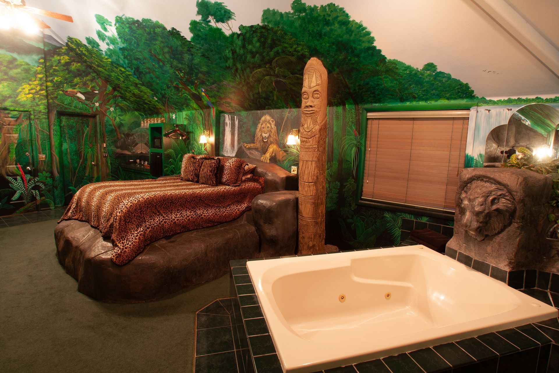 A bedroom with a leopard print bed and a jacuzzi tub