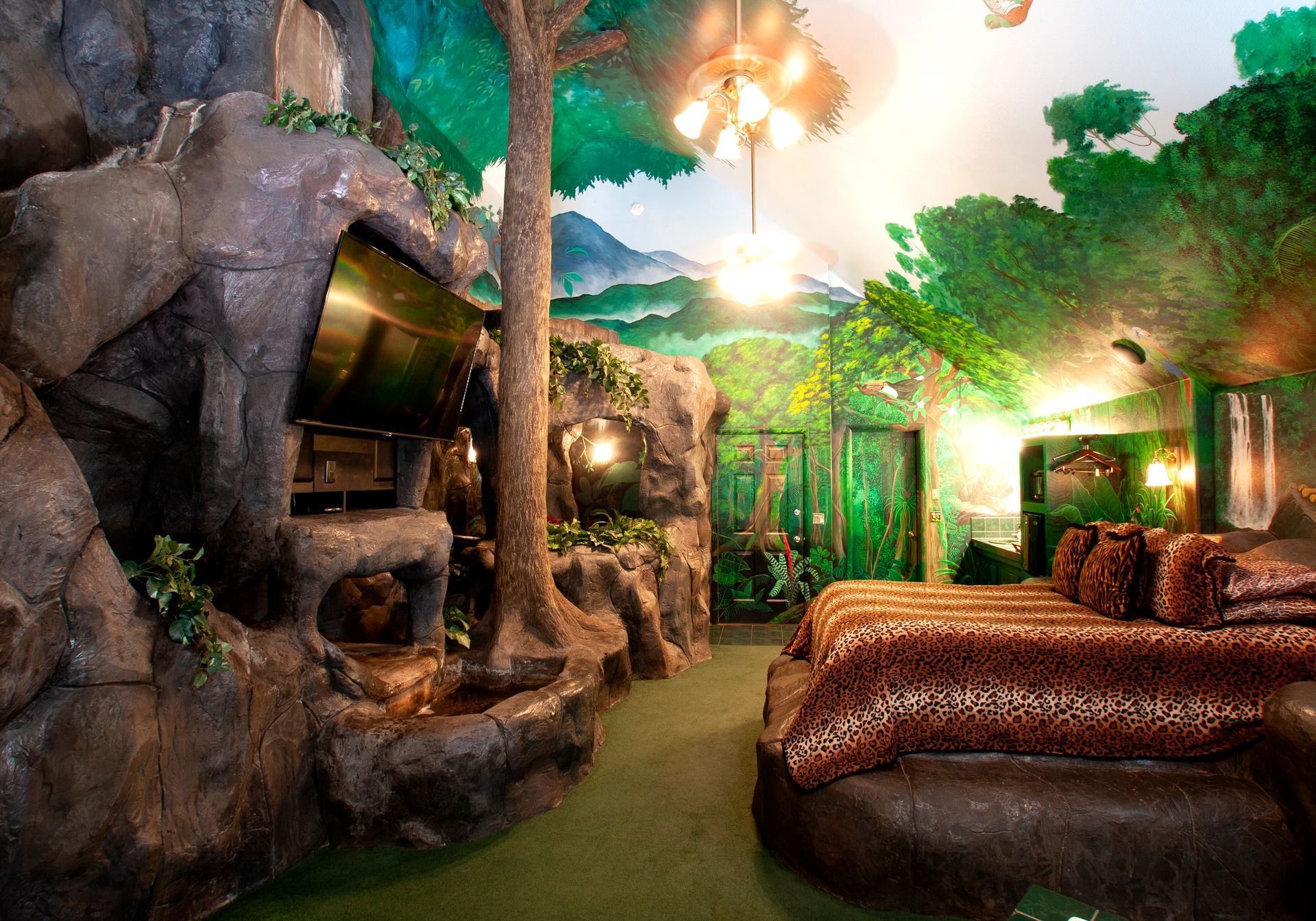 A bedroom that looks like a jungle with trees and rocks