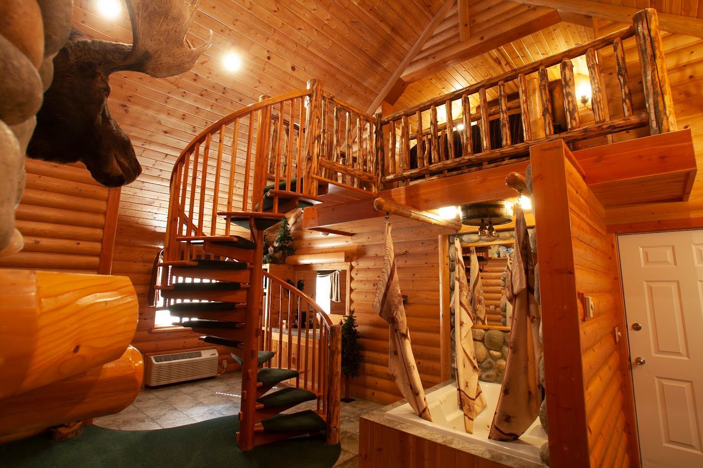 A wooden house with a spiral staircase leading to the second floor