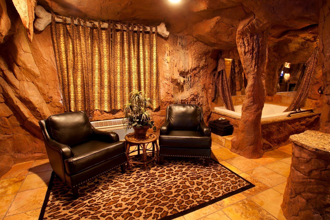 A living room with two chairs and a leopard print rug
