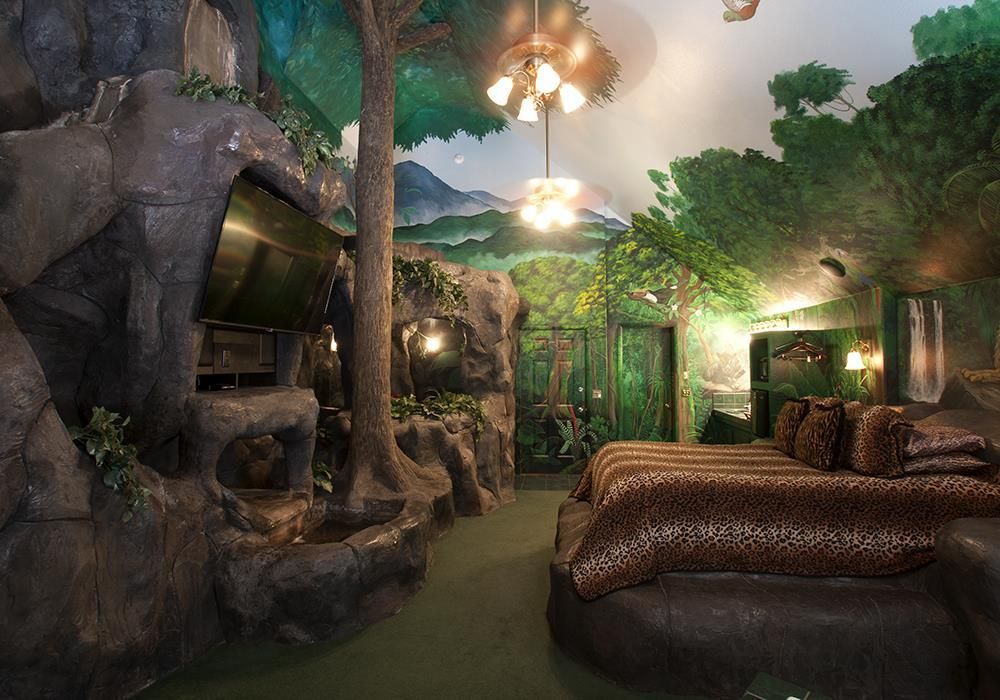 A room with a couch and a bed that looks like a jungle