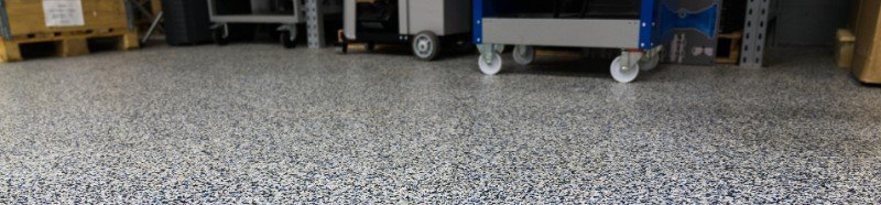 A garage with a concrete floor and a cart on it.