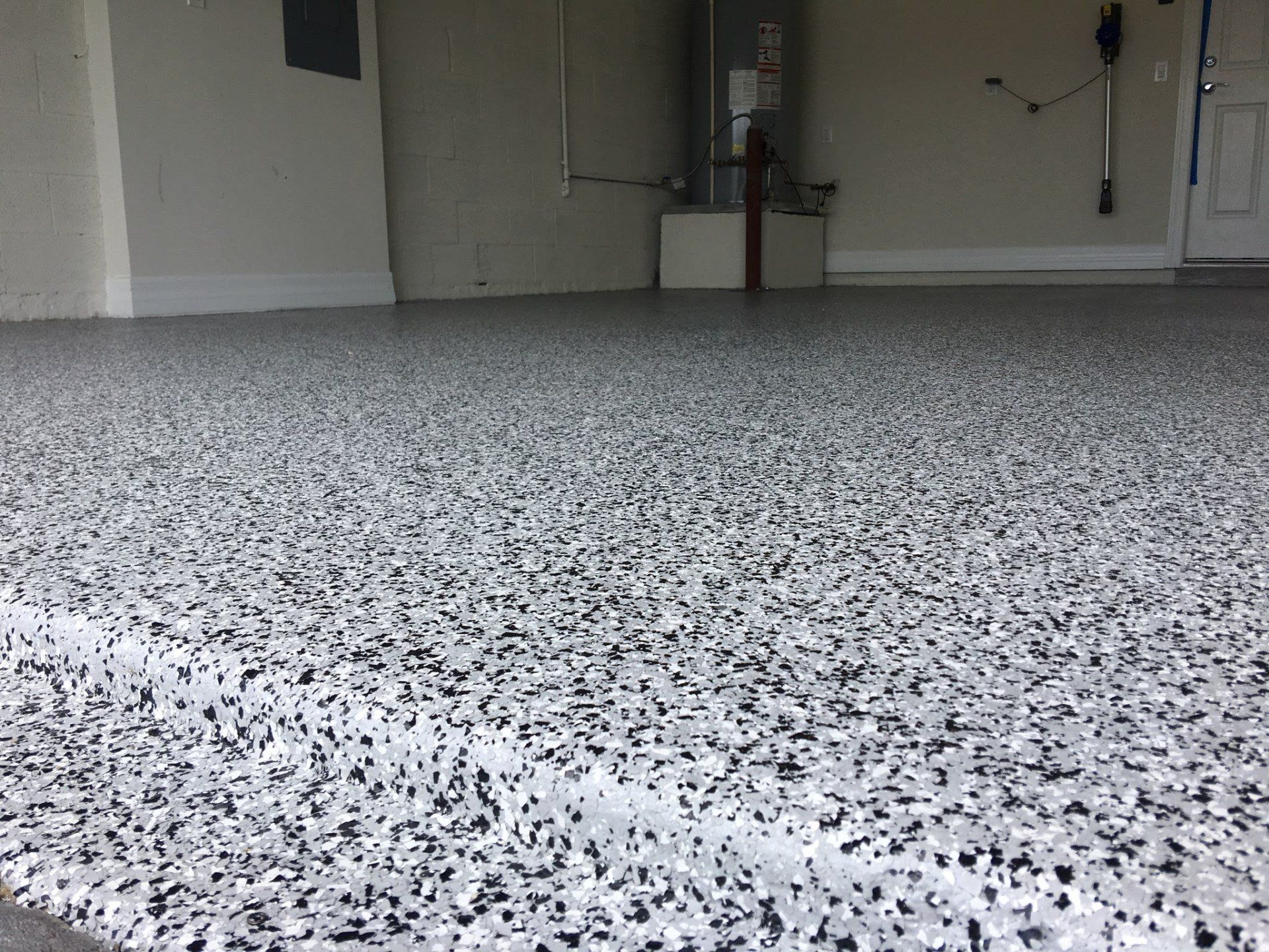 A garage floor with a lot of small stones on it.