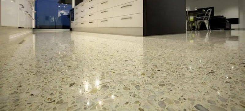 A close up of a shiny concrete floor in a kitchen.
