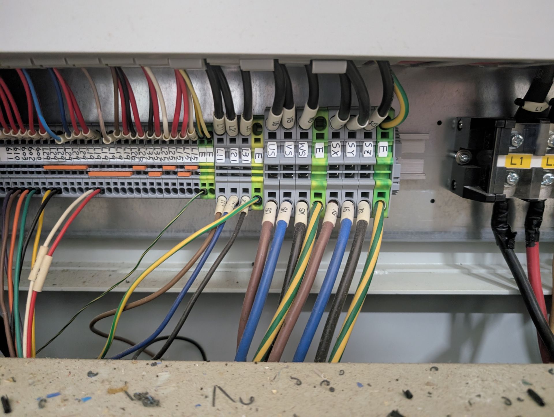 Electrical control panel with wires connected to terminal blocks, various colors.