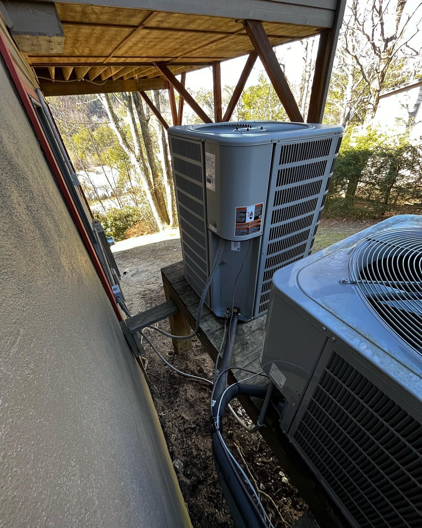 A couple of air conditioners are sitting on top of a wooden table.
