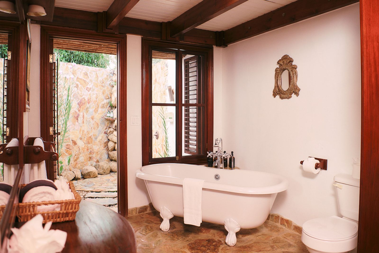 Timeless bathroom with clawfoot tub and natural stone accents, creating a luxurious, tranquil retreat.