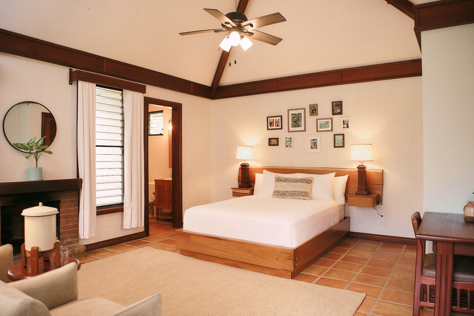 A bedroom with a large bed and a ceiling fan