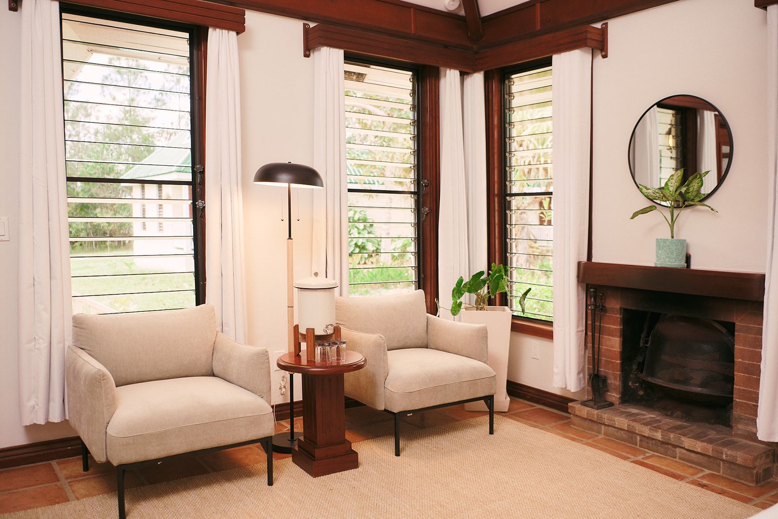 A living room with two chairs and a fireplace.