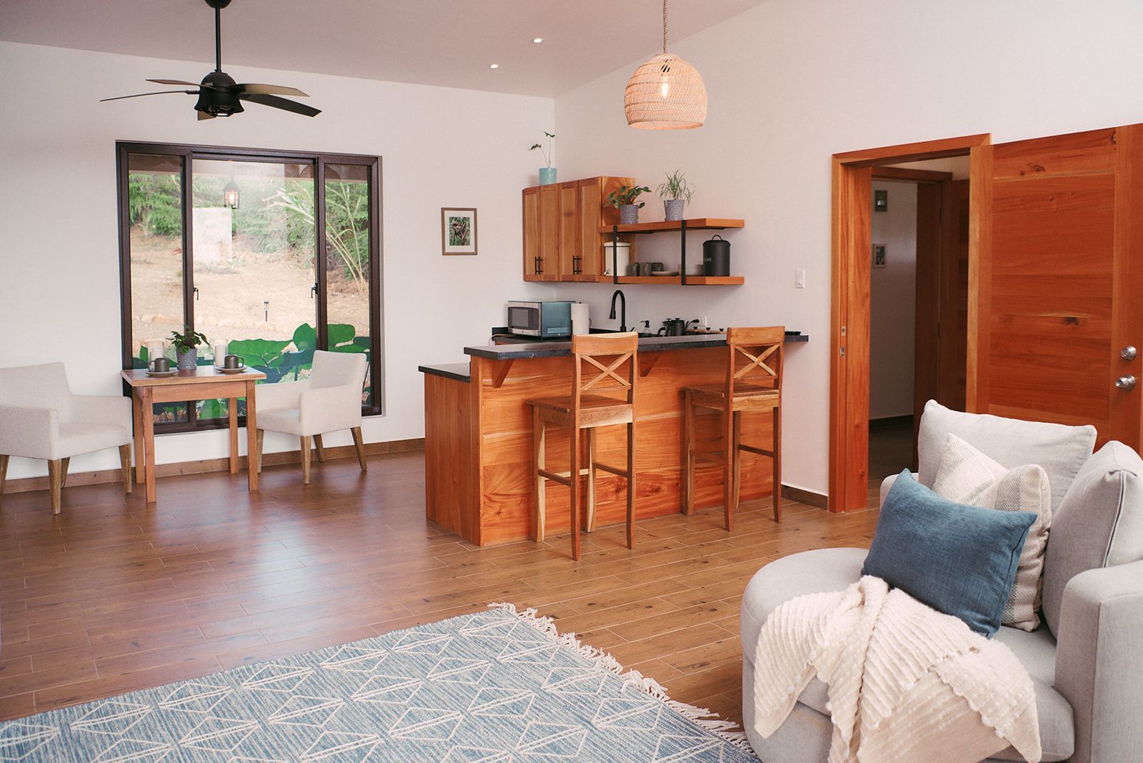 A spacious and elegantly designed living area in the Valley View Villas, with modern wooden furniture, a cozy sitting area.