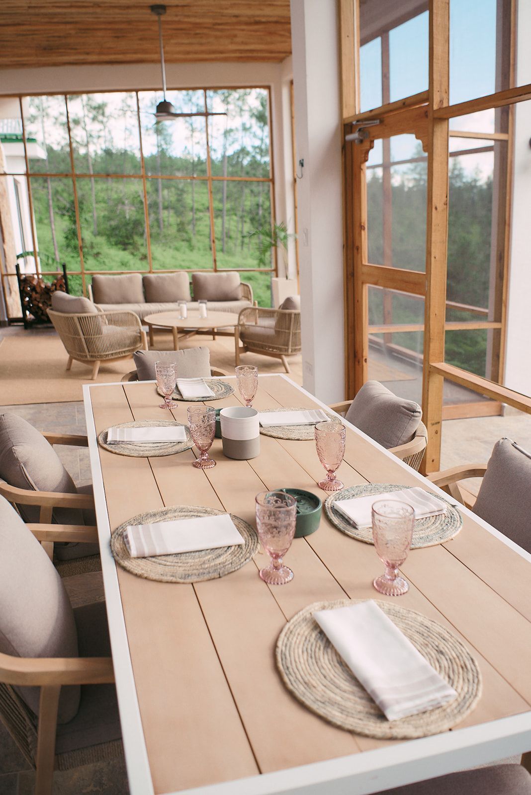Elegant dining setup in an airy outdoor veranda with a view of the forest at Hidden Valley.