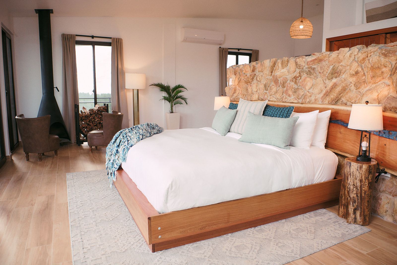 Elegant room with cozy fireplace, leather furnishings, and plush bedding, perfect for a romantic escape.
