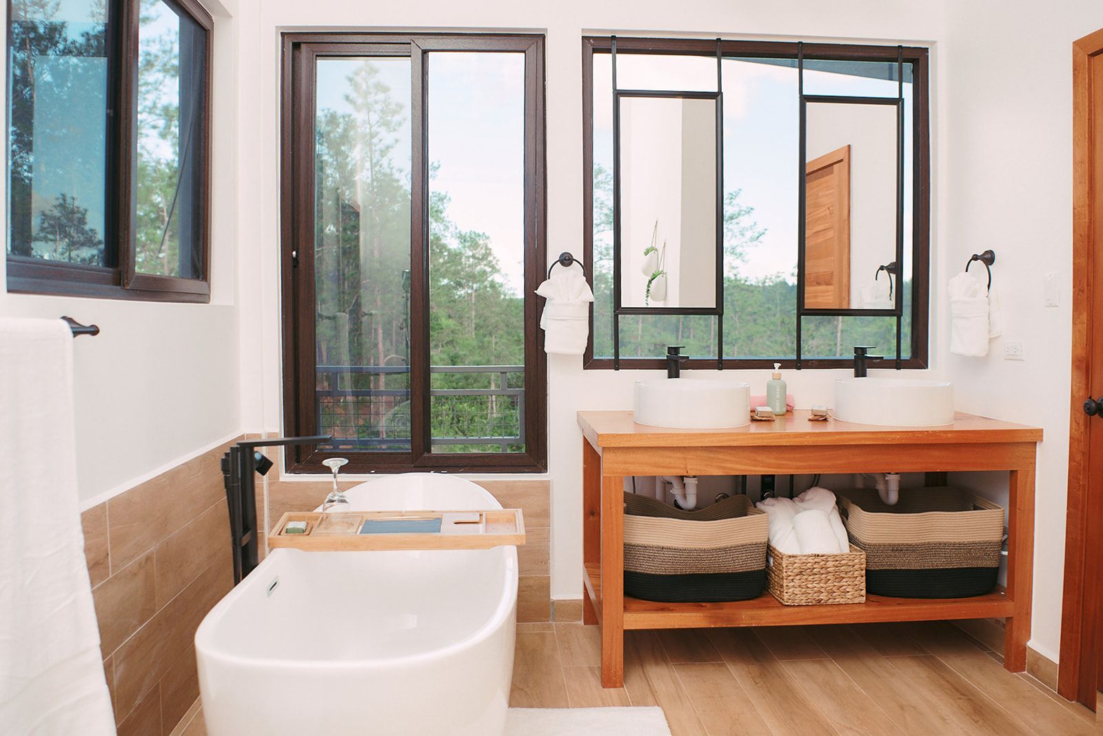 Spacious bedroom with floor-to-ceiling windows overlooking the serene pine forest at Fire Tower, perfect for couples.