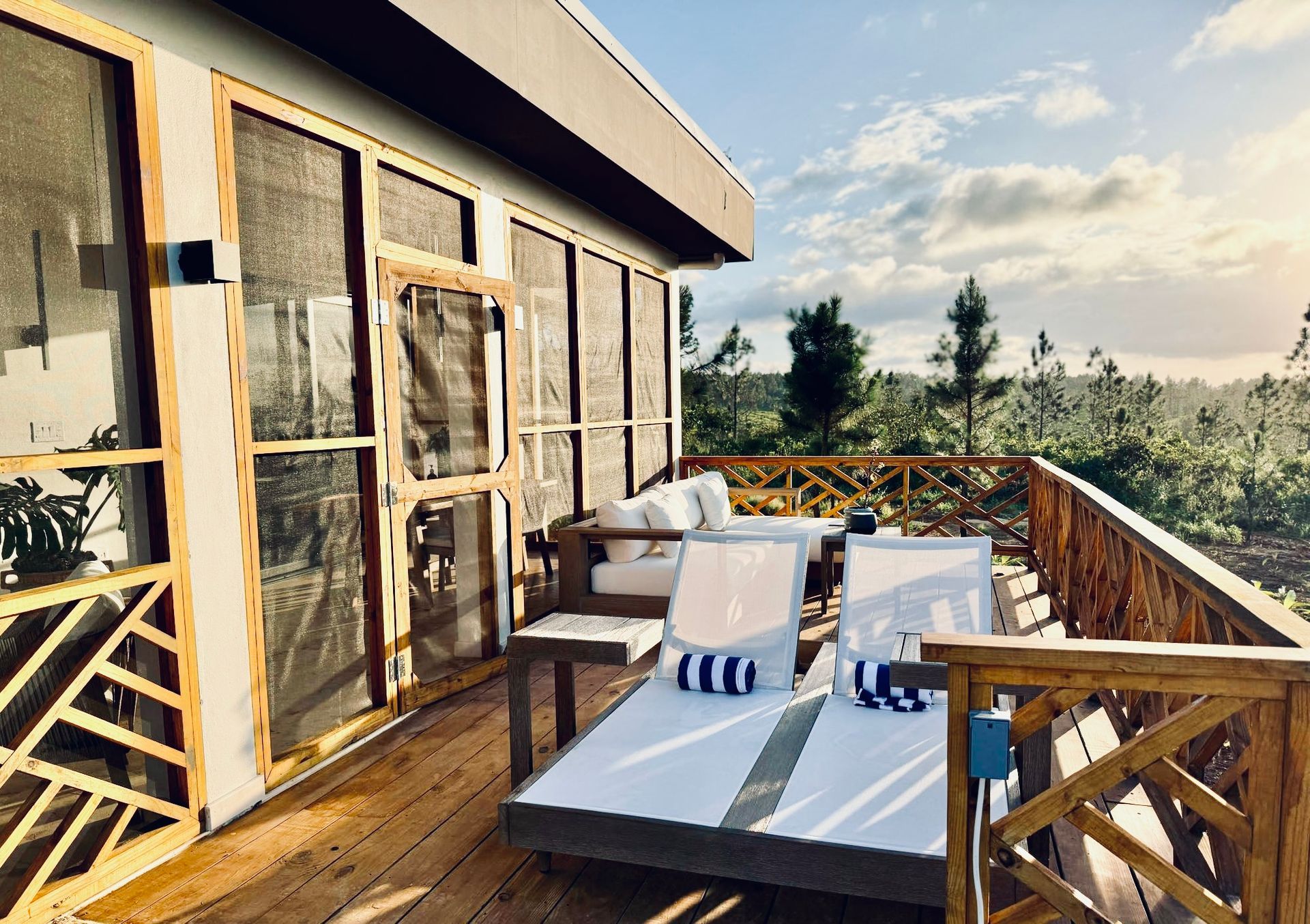 A wooden deck with chairs and a couch on it