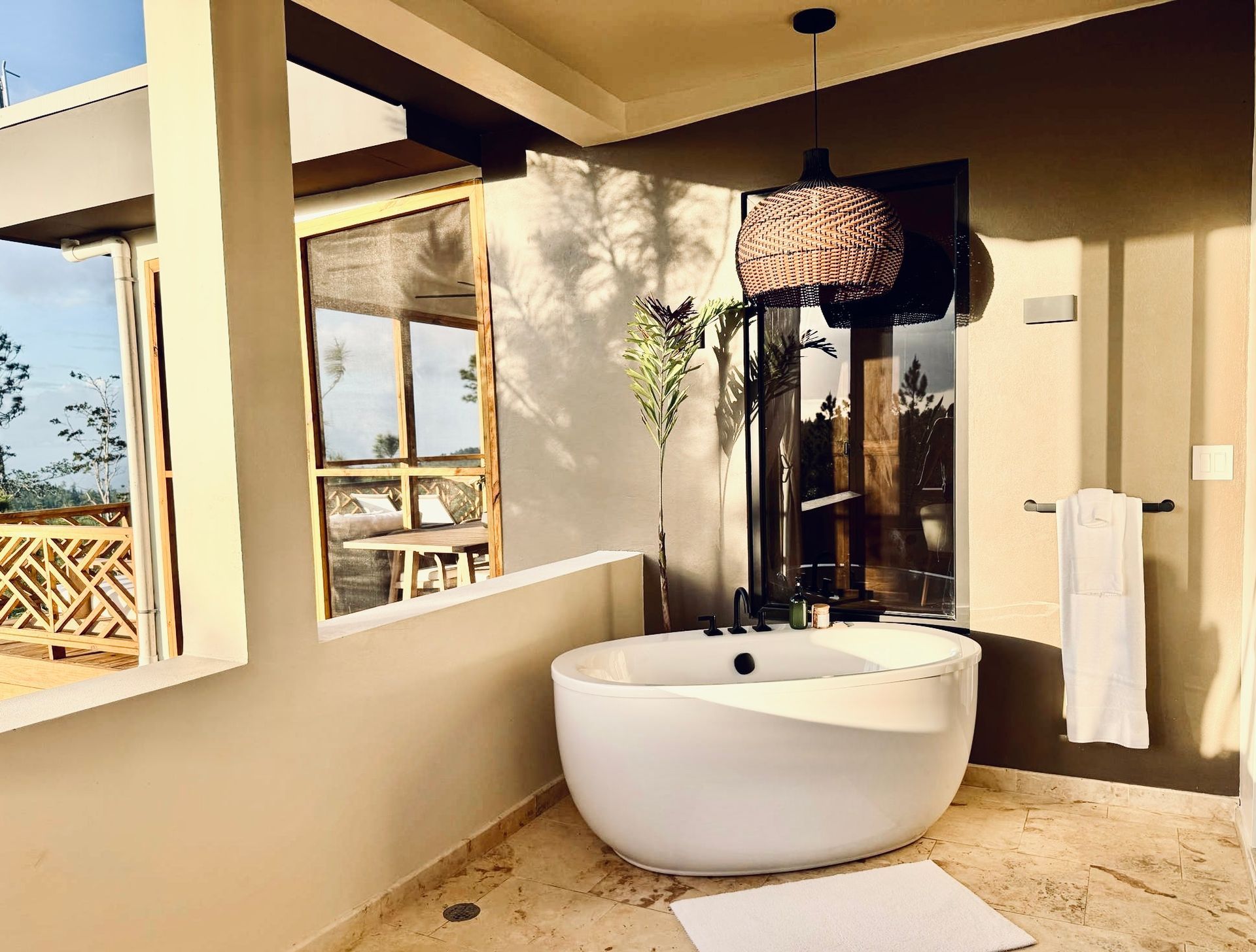 A bathroom with a large tub and a window