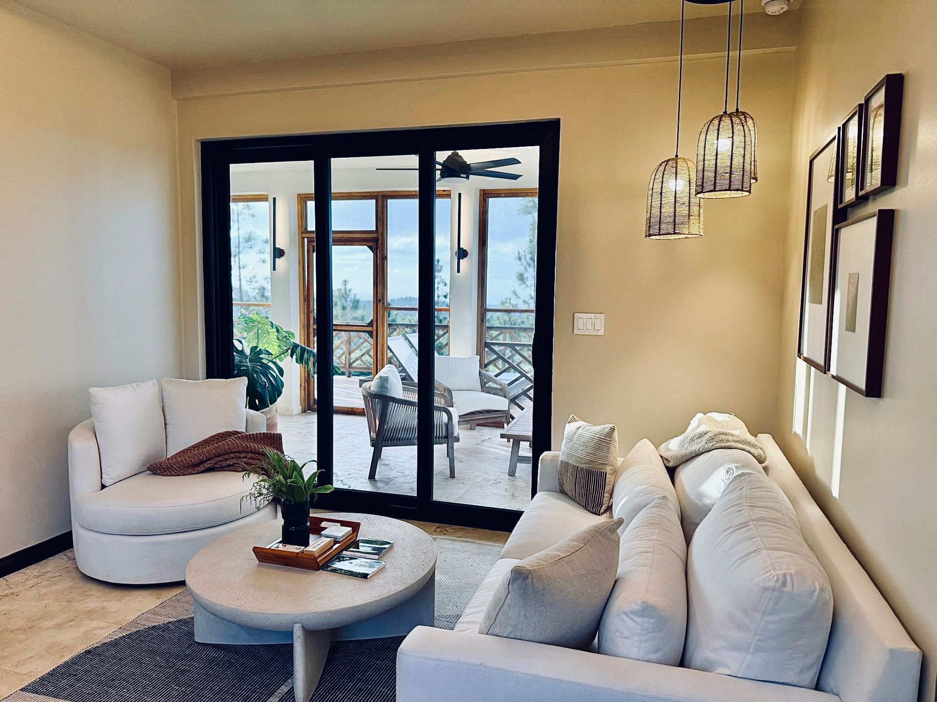 A living room with a couch , chair , table and sliding glass doors.