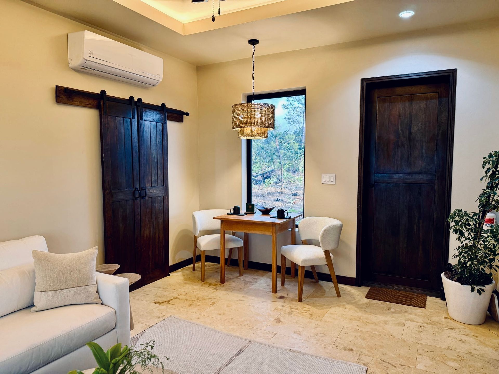A living room with a couch , table and chairs.