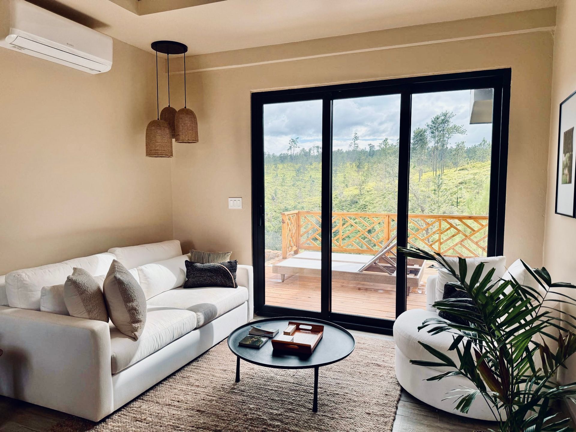 A living room with a couch , coffee table , and sliding glass doors.