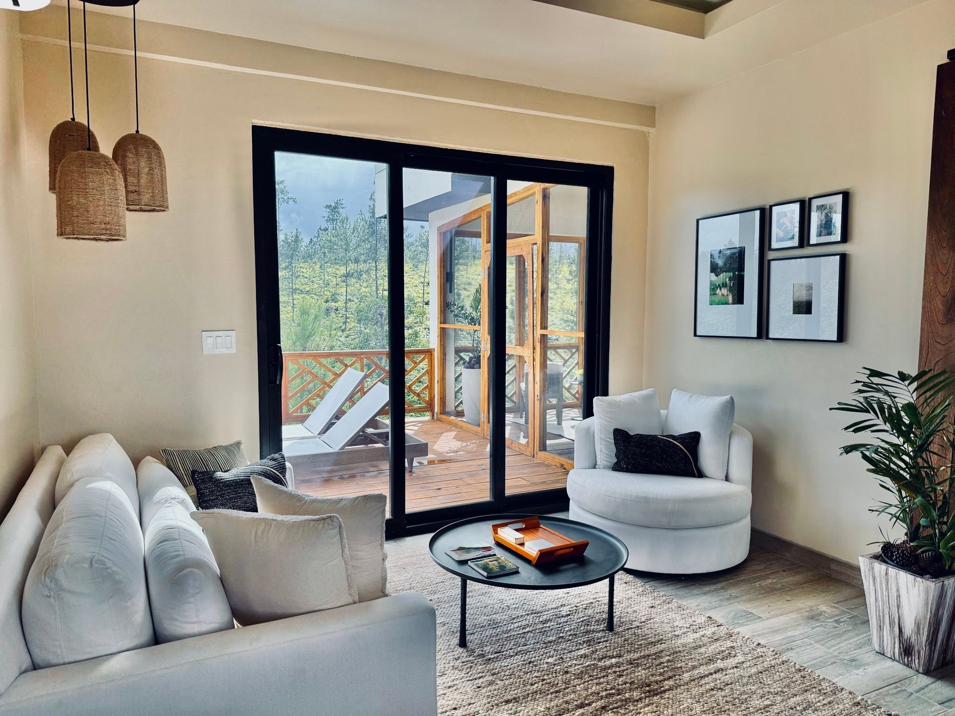 A living room with a couch , chair , coffee table and sliding glass doors.