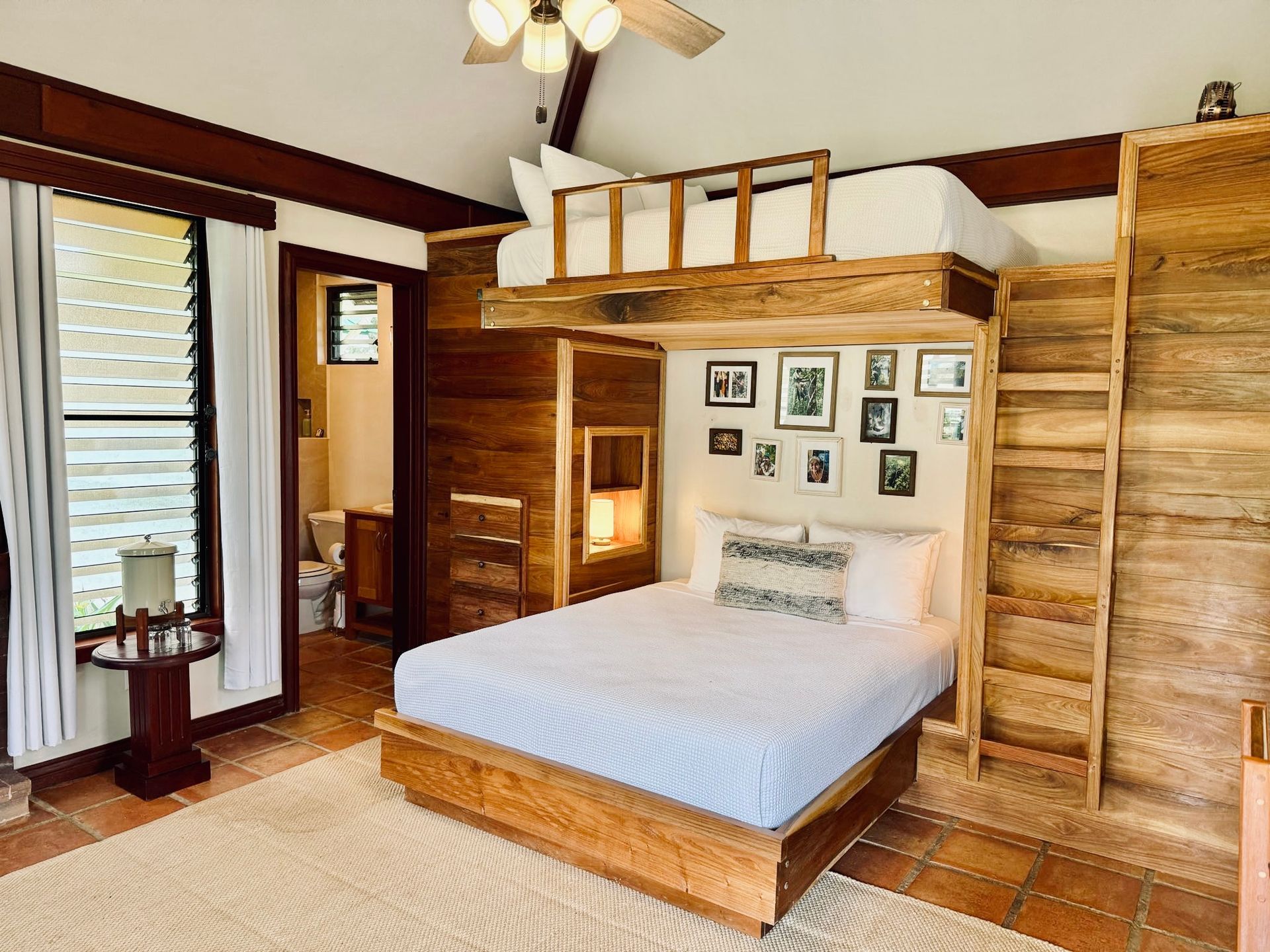 A bedroom with a king size bed and a bunk bed.