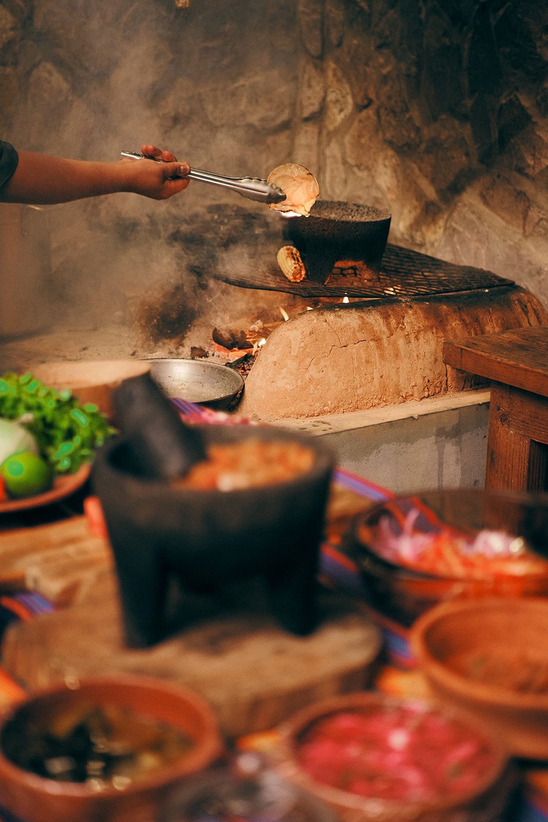 A person is cooking food on a stove in a kitchen.