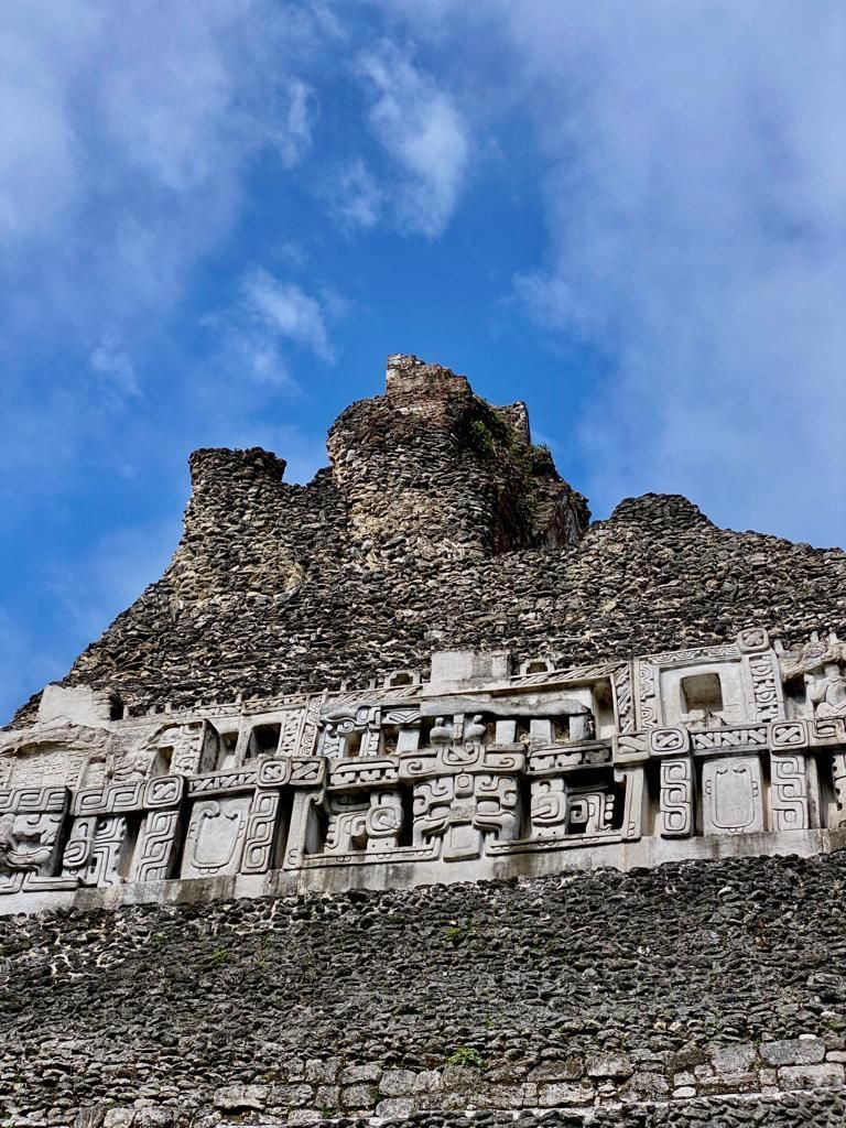 A large stone pyramid with a blue sky in the background