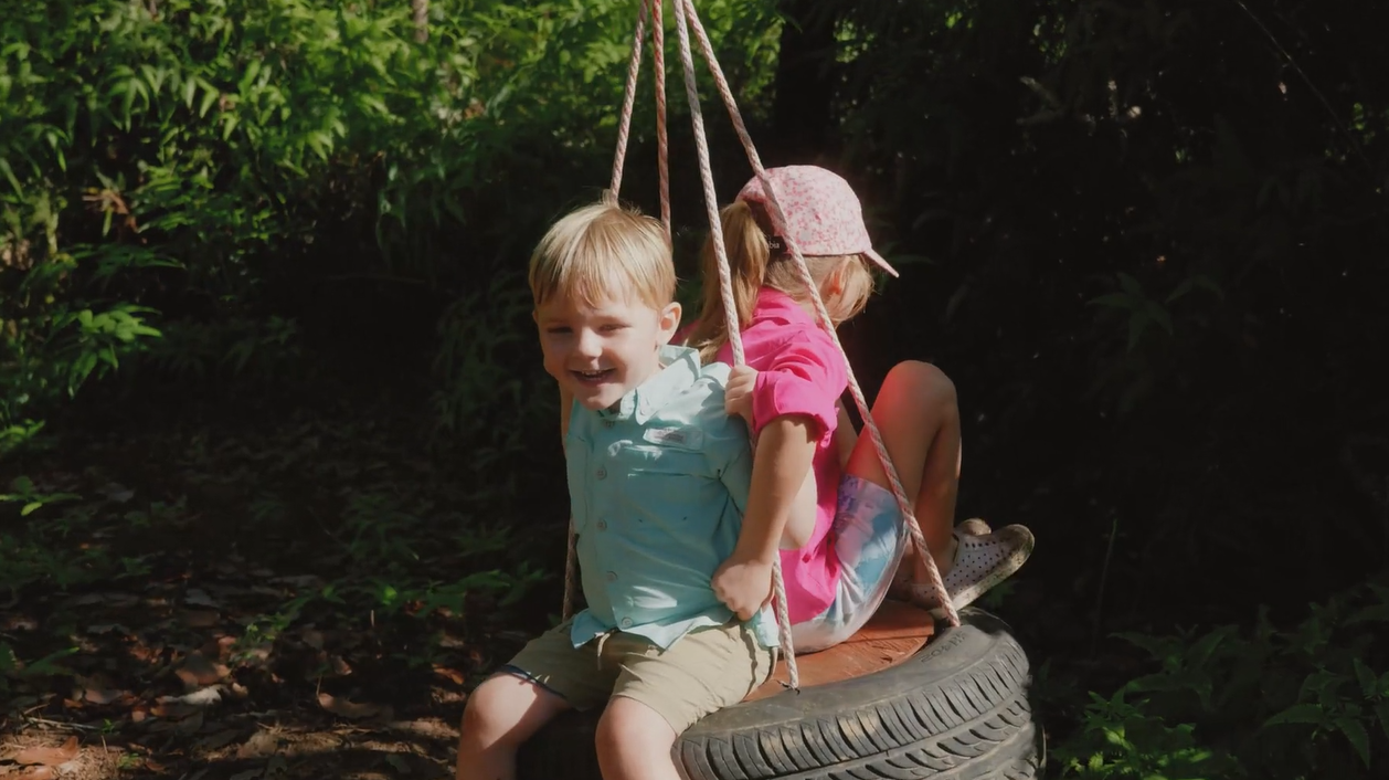 Kids enjoying a tire swing on Hidden Valley’s nature trails.