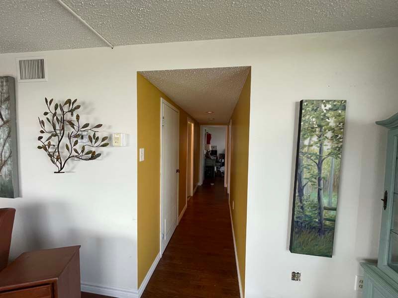 A hallway in a house with a tree on the wall