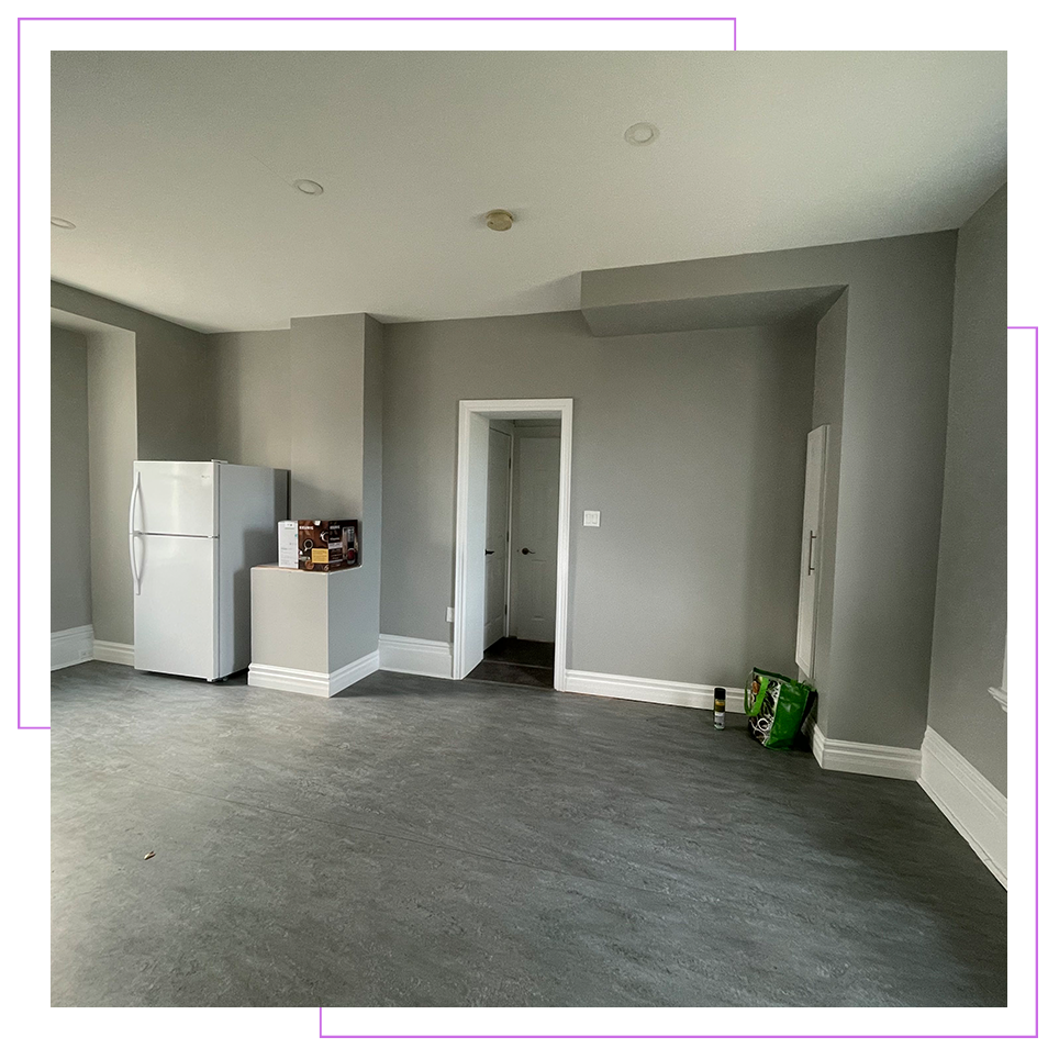 There is a refrigerator in the middle of the room.