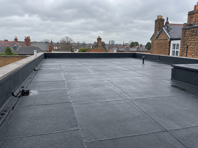 New torch-on felt flat roof with felt upstands and a roof outlet