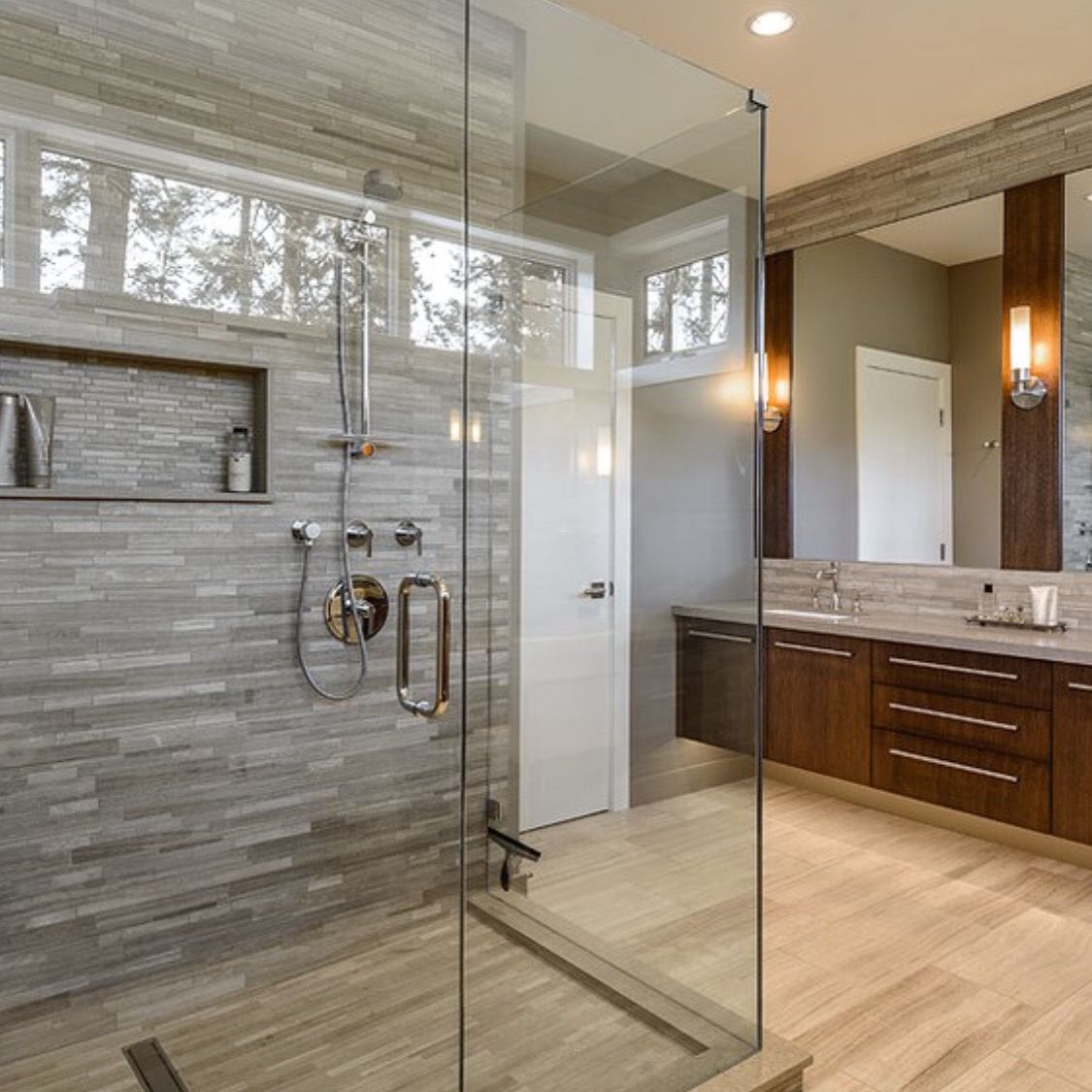A bathroom with a walk in shower and a sink.