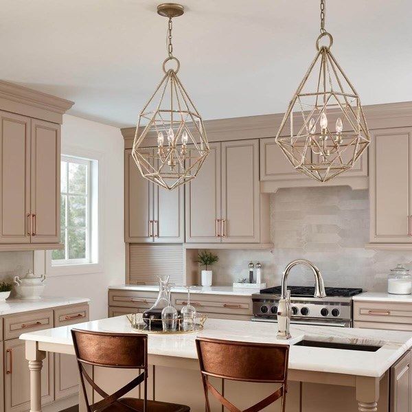 A kitchen with a large island and two chairs
