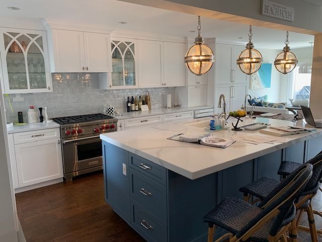 A kitchen with a large island and a stove.