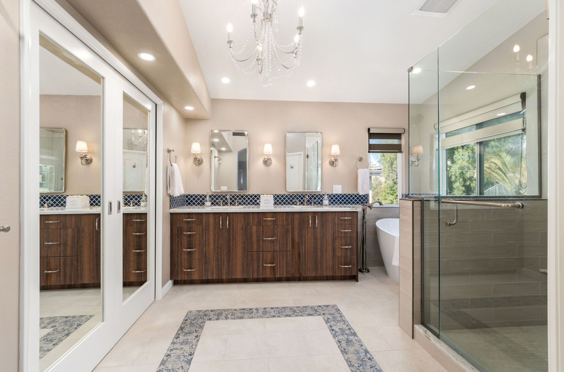 A bathroom with two sinks and a walk in shower