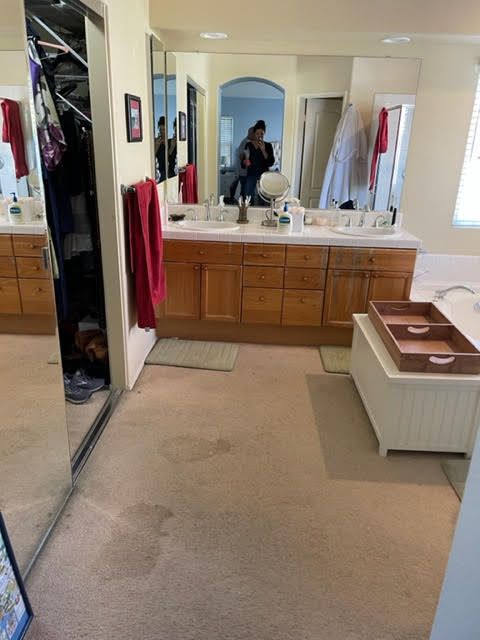 A bathroom with two sinks and a large mirror