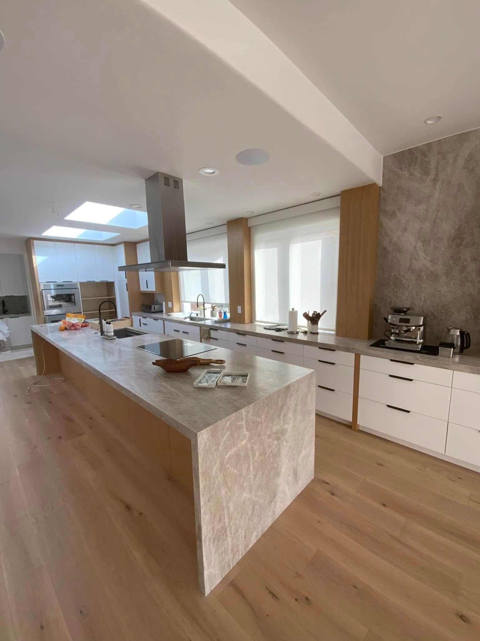 There is a large island in the middle of the kitchen.