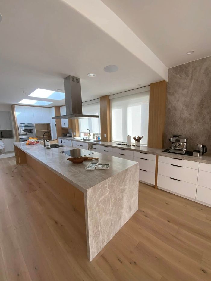 There is a large island in the middle of the kitchen.