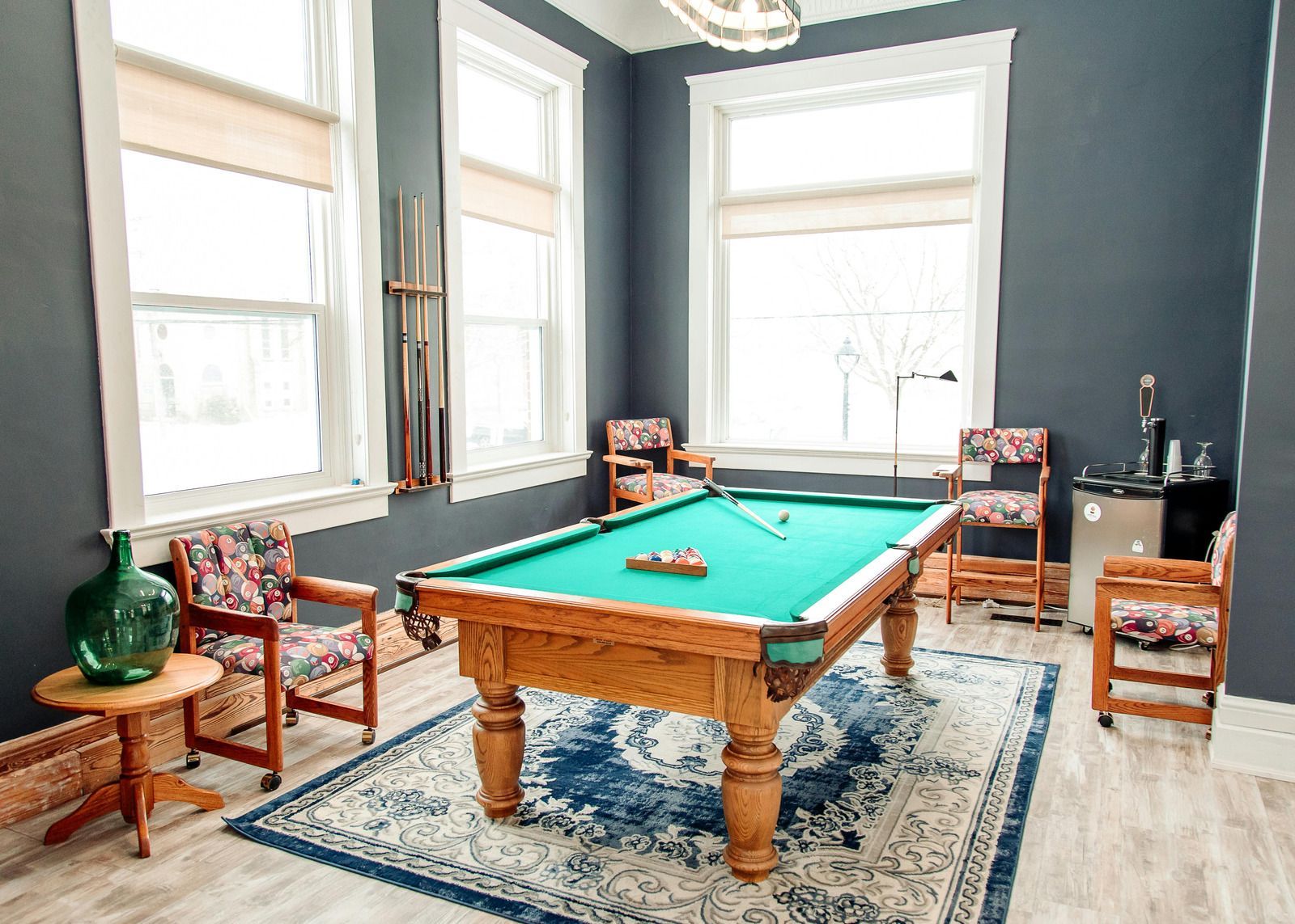 There is a pool table in the middle of the room.