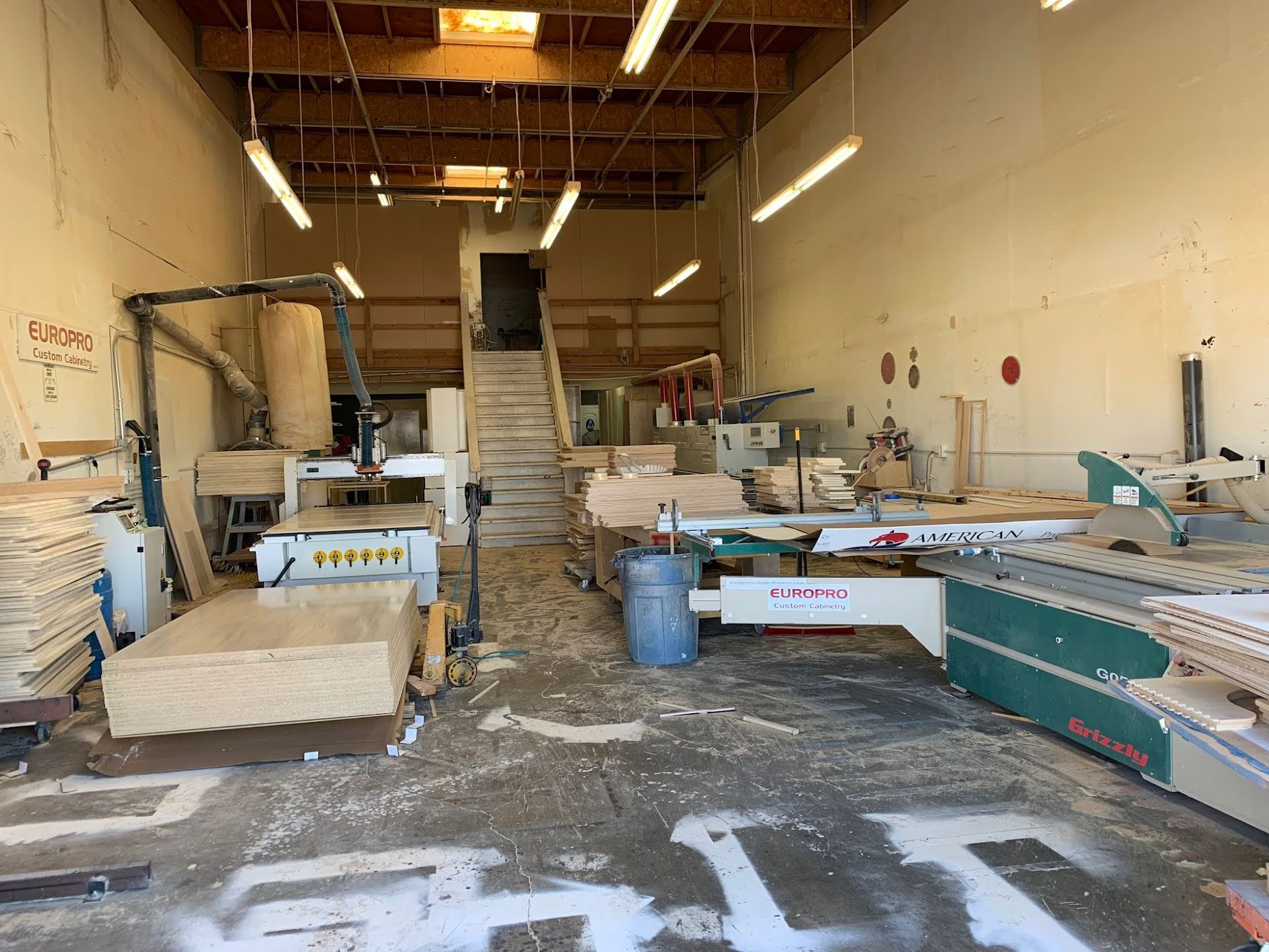 A woodworking shop with a lot of wood and machinery.