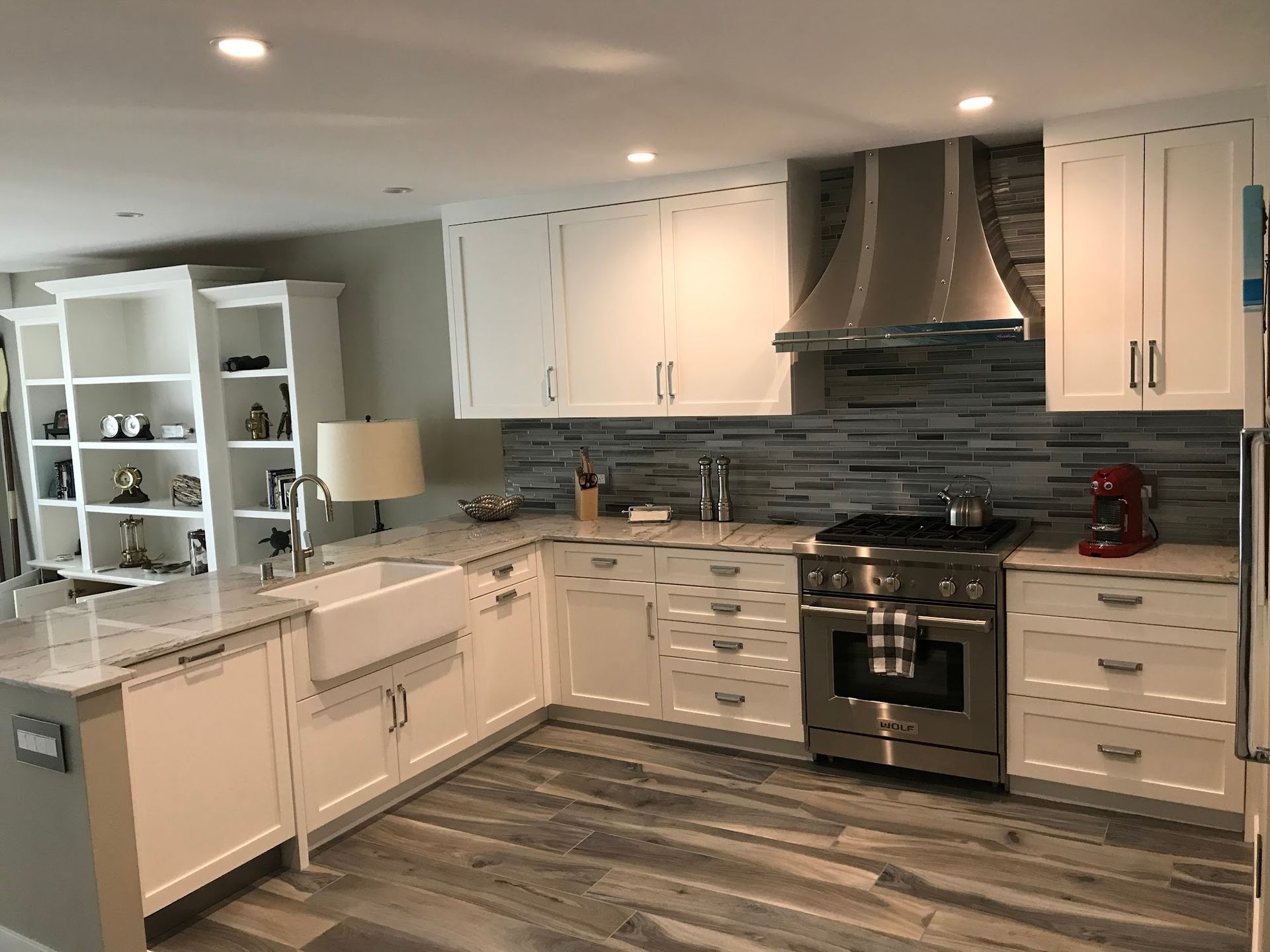 A kitchen with white cabinets and stainless steel appliances.
