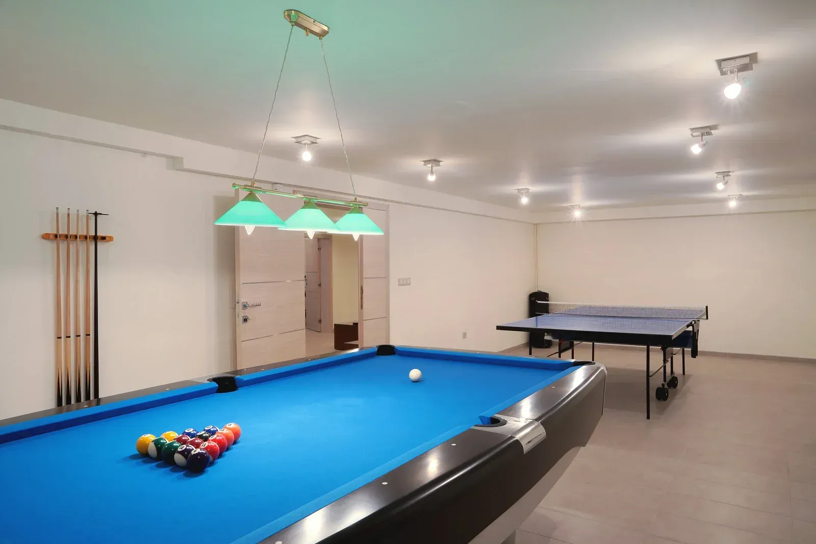 There is a pool table and a ping pong table in the room.
