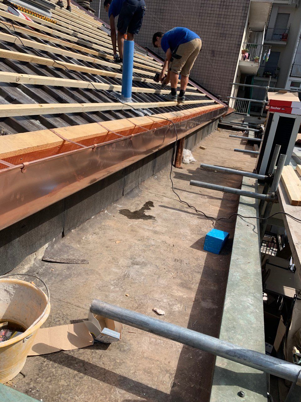 tecnici durante l'installazione di una grondaia in rame