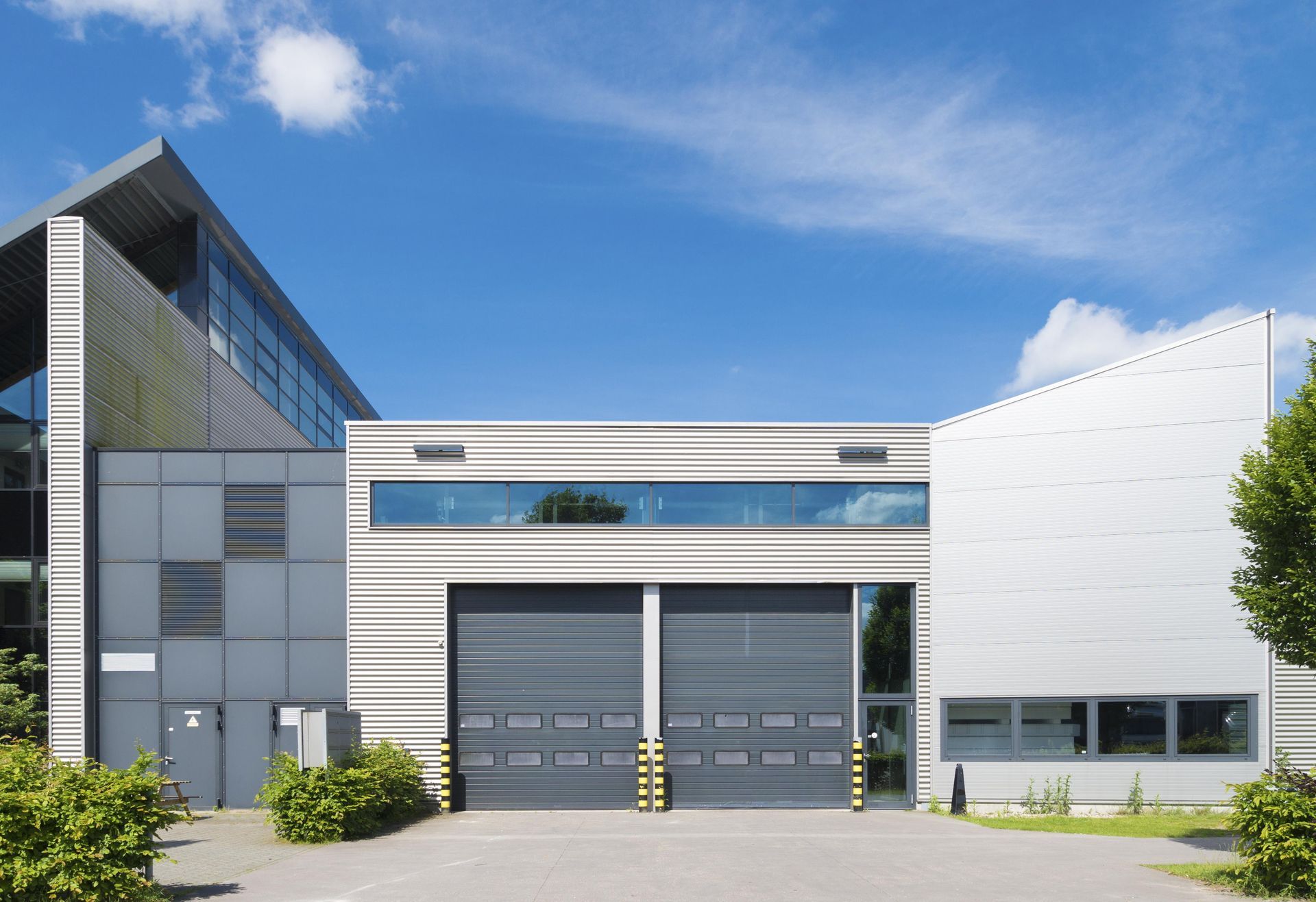 A large building with a lot of windows and a lot of garage doors.