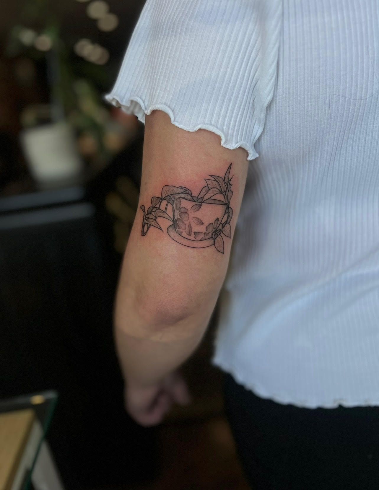 A person with a tattoo on their arm.