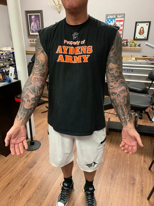 Woman wearing large glasses, looking upwards, in a shop with displays.