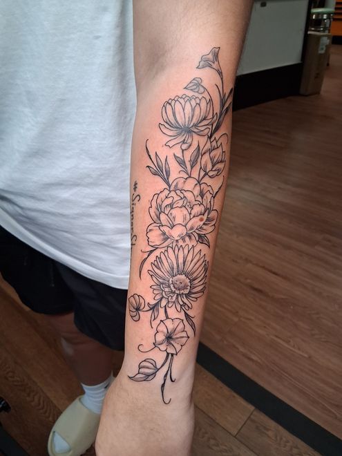 Hand tattoo: Cross inside a rose.